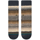 SMOKEY MOUNTAIN C SOCK 2024 - A pair of tan and gray striped socks with a small green logo on the ankle.