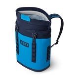 Yeti Hopper M12 Backpack Soft Cooler - A large, navy-blue backpack with a zippered front pocket and two side pockets, featuring a handle on top and adjustable shoulder straps.