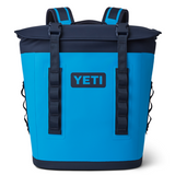 Yeti Hopper M12 Backpack Soft Cooler - A large, blue backpack-style cooler with a zippered top and two adjustable shoulder straps.