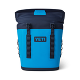 Yeti Hopper M12 Backpack Soft Cooler - A large, blue backpack-style cooler with a zippered main compartment and two side pockets.