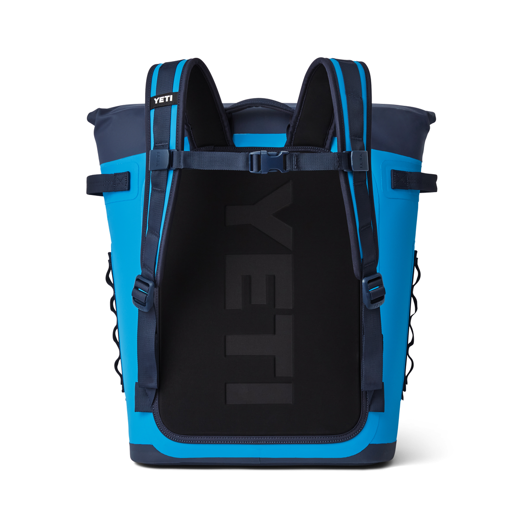 Yeti Hopper M20 Soft Backpack Cooler - A large, blue cooler with a zippered main compartment and two side pockets, featuring a shoulder strap and a handle on top.