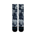 Tropic Chill Kids Sb Sock 2022 - A pair of navy blue socks with a tropical print featuring palm trees and leaves in white, gray, and light blue hues.
