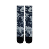 Tropic Chill Kids Sb Sock 2022 - A pair of navy blue socks with a tropical print featuring palm trees and leaves in white, gray, and light blue hues.