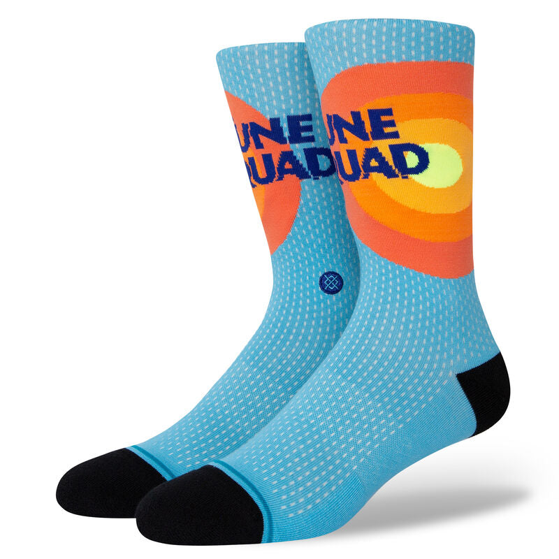 Tune Squad Crew C Sock 2022 - A pair of crew socks with a light blue background and white dots, featuring an orange and yellow circle design on the top portion.