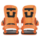 Pair of orange snowboard bindings, front view, with black soles and straps
