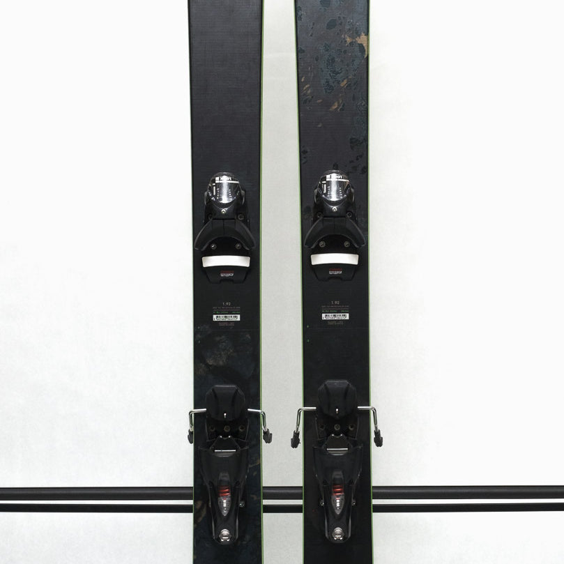 USED - Rossignol Black Ops Holyshred with SPX12 Bindings - A pair of black skis with white lettering and silver bindings.