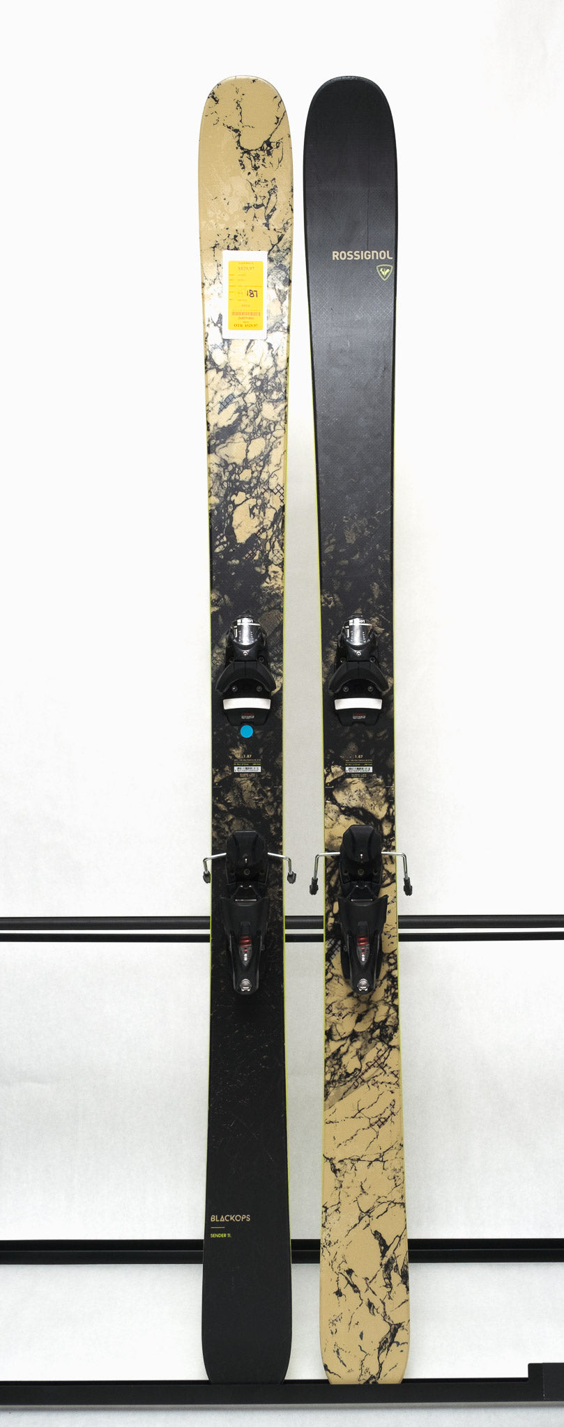 USED - Rossignol Black Ops Sender Ti with SPX 12 Bindings - A black ski with a yellow sticker on its tip and silver bindings.