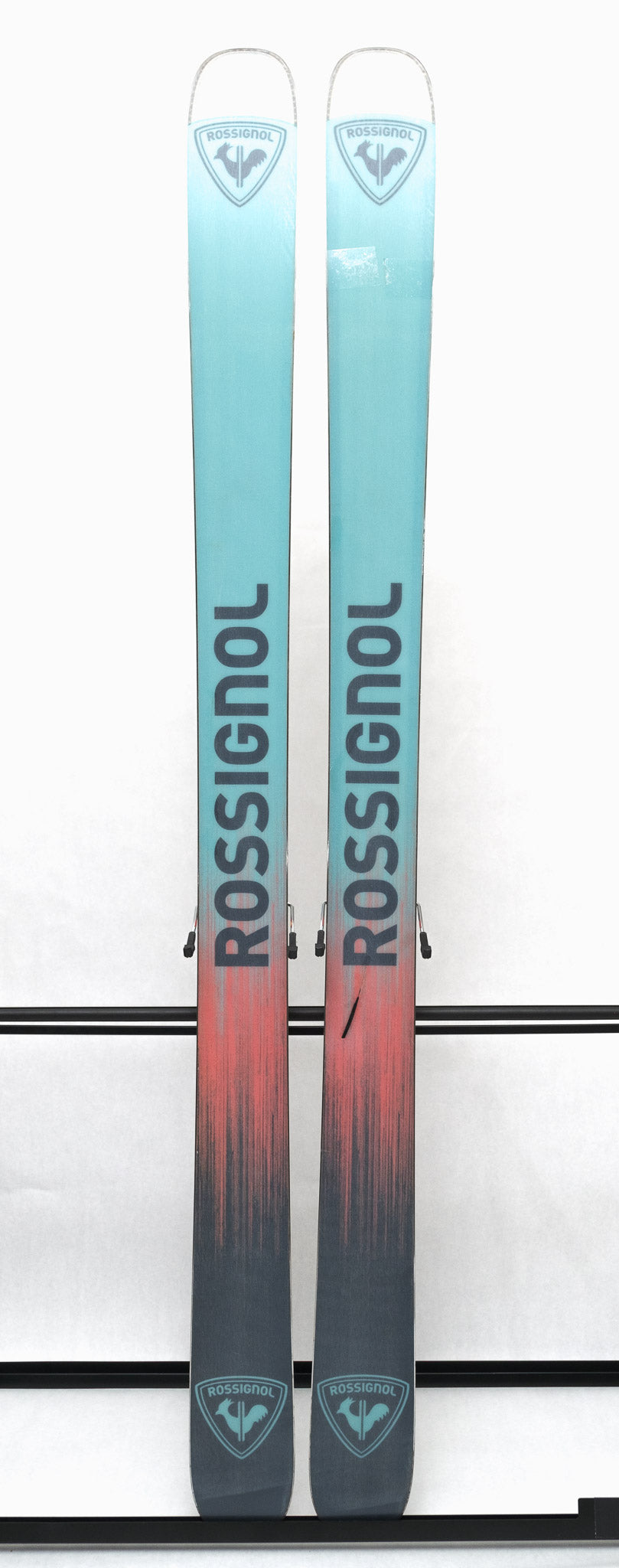 USED - The skis are light blue with a darker blue logo and lettering.