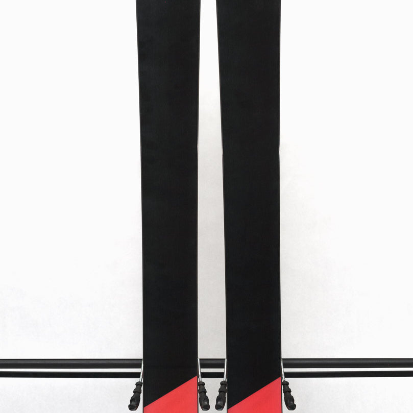 USED - Head Kore 99 with Attack 14 Bindings - A pair of skis with a black base and white lettering, featuring the word "HEAD" on one ski and "KORE" on the other.