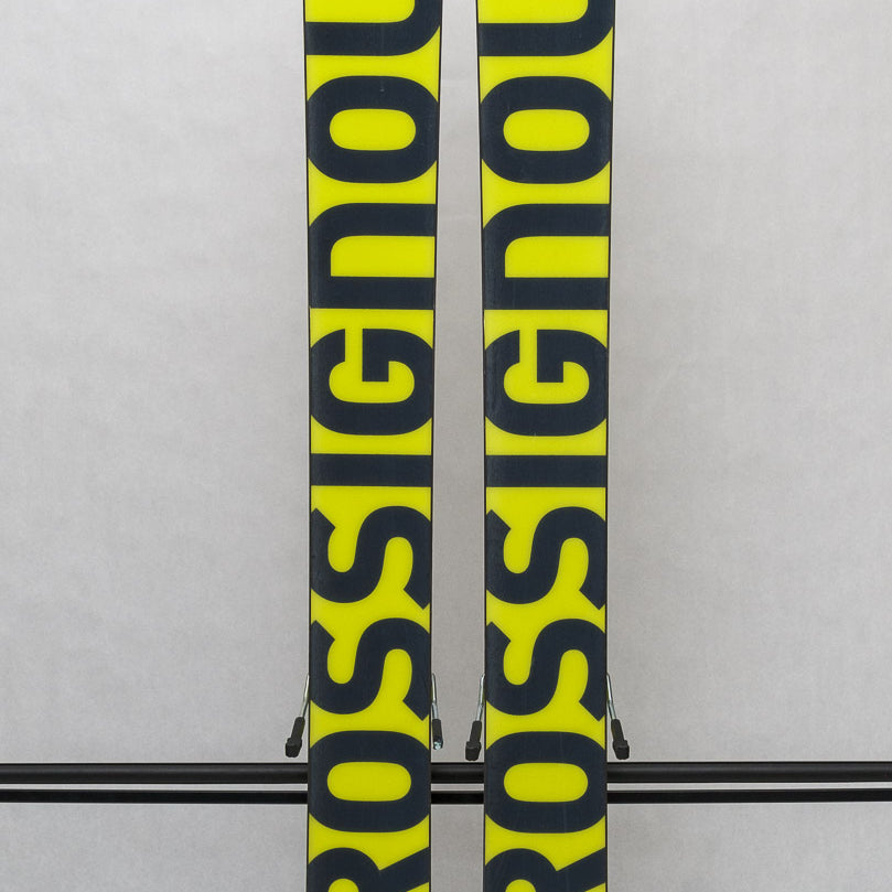 USED - Rossignol Black Ops Sender Ti with SPX 12 Bindings - A pair of skis featuring a sleek black design, with silver bindings and a subtle sheen on the surface.