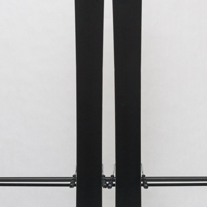 USED - Rossignol Black Ops Escaper with AM 12 Bindings - A pair of skis with black bases and white tops, featuring a distinctive logo on the top of each ski.