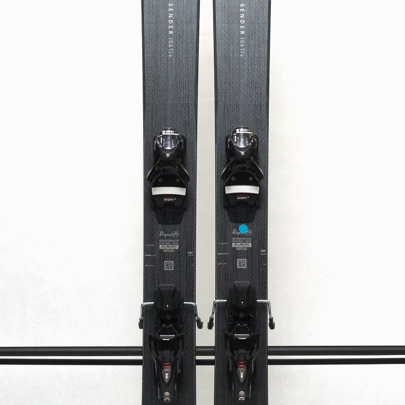 USED - Rossignol Sender 106 Ti+ 2024 with SPX12 Demo Bindings - A pair of skis with a dark gray base and white lettering, featuring the Rossignol logo on the top.