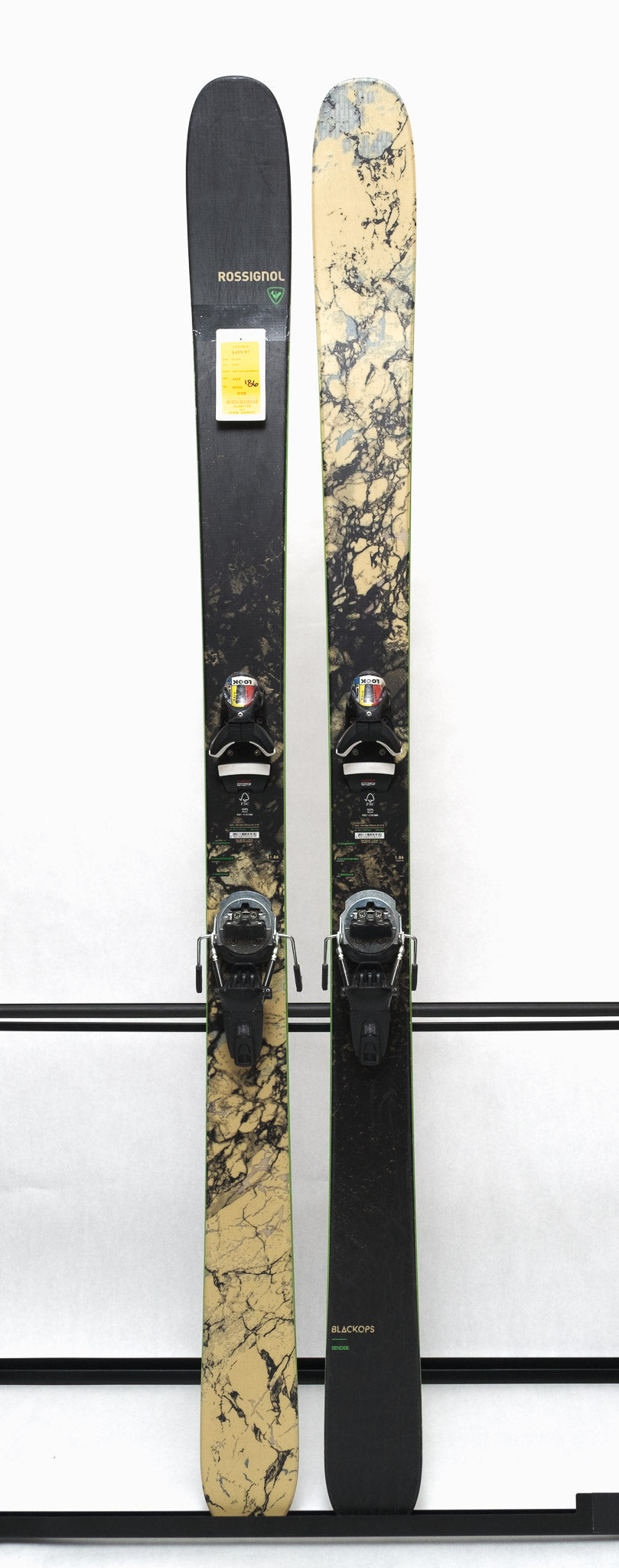 USED - Rossignol Black Ops Sender Ti with Pivot 12 Bindings - A black ski with a white and gray marbled pattern on the top sheet, featuring a green outline around the edges.