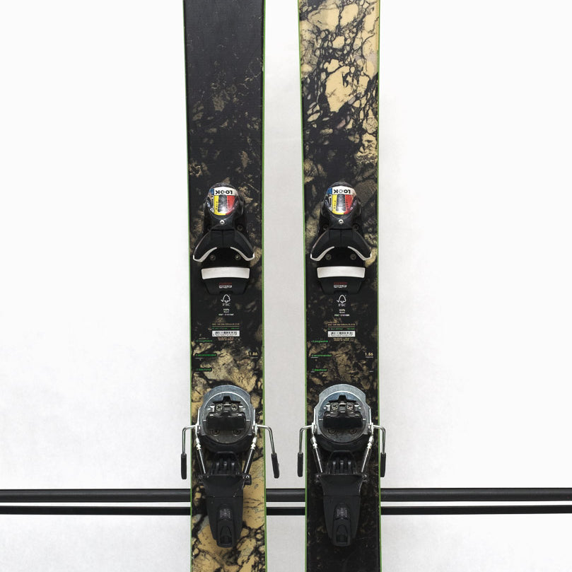 USED - Rossignol Black Ops Sender Ti with Pivot 12 Bindings - A black ski with a white and gray marbled pattern on the top sheet, featuring a green outline around the edges.