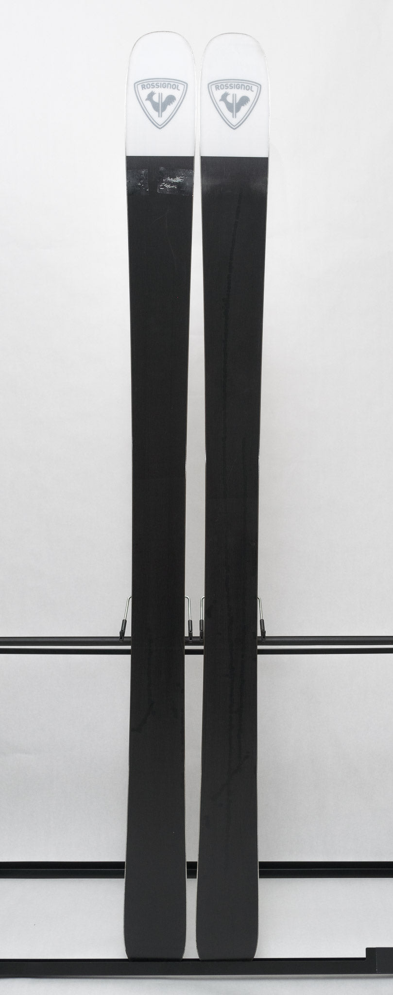 USED - Rossignol Black Ops Sender Ti with Pivot 12 Bindings - A pair of skis featuring a sleek black finish and silver bindings.