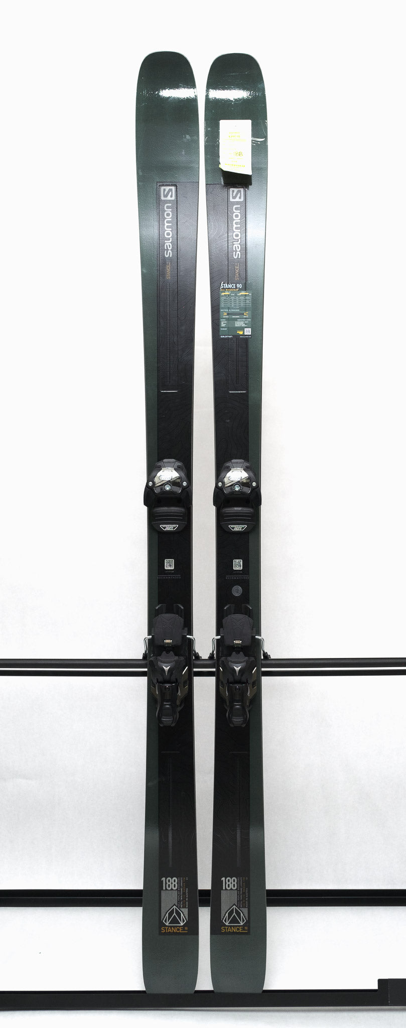 USED - Salomon Stance 90 2022 with Warden 13 Bindings - A pair of skis with a dark green base color and white lettering, featuring the Salomon logo on the top.