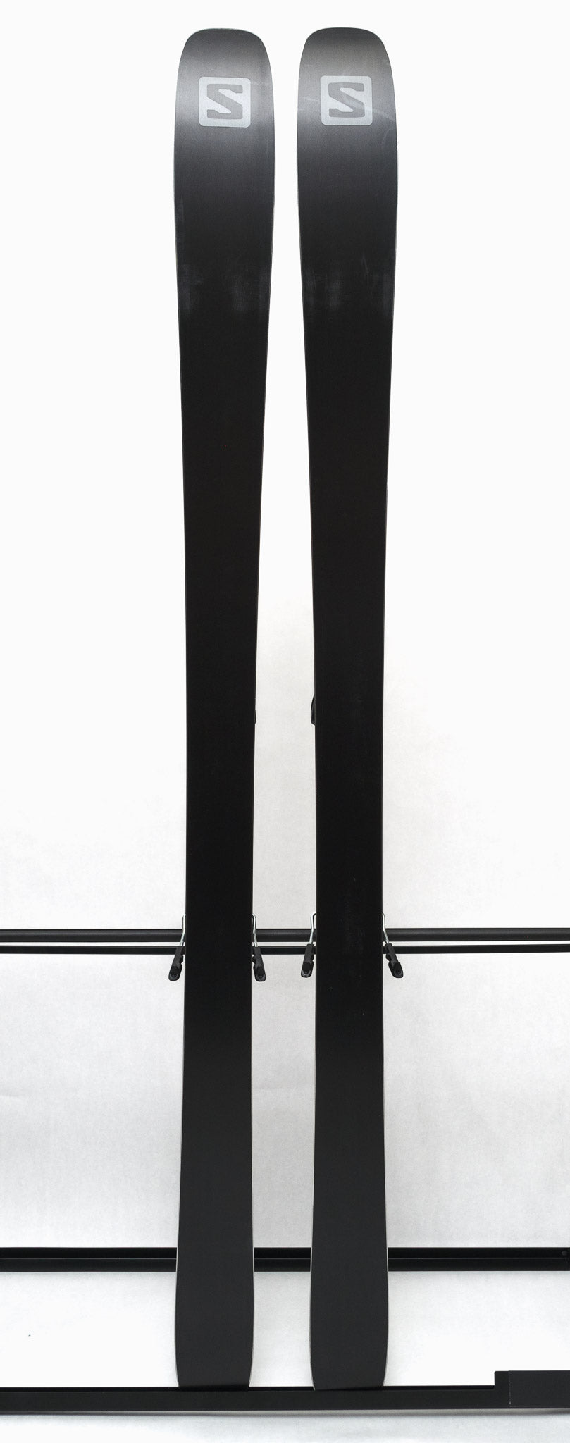 USED - Salomon Stance 90 2022 with Warden 13 Bindings - A pair of skis with a black base and white lettering, featuring the Salomon logo on the top.