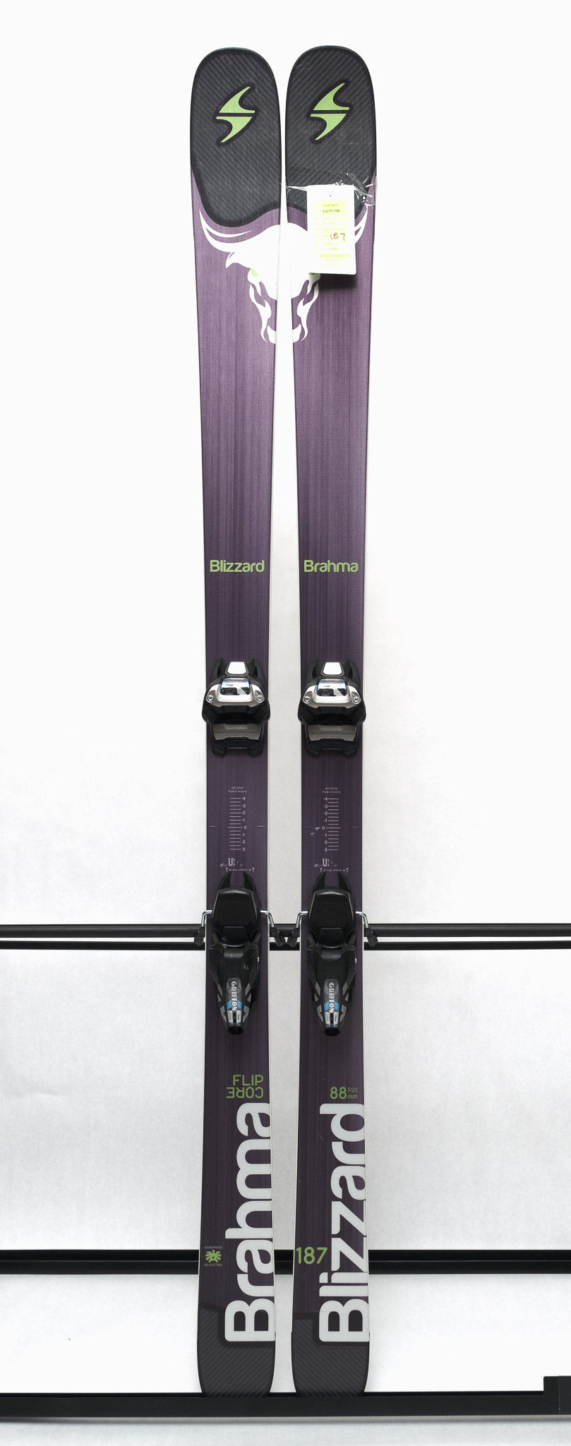USED - Blizzard Brahma 88 with Griffon 13 Bindings - A pair of skis with a purple base and white lettering, featuring a distinctive bull logo on the top sheet.