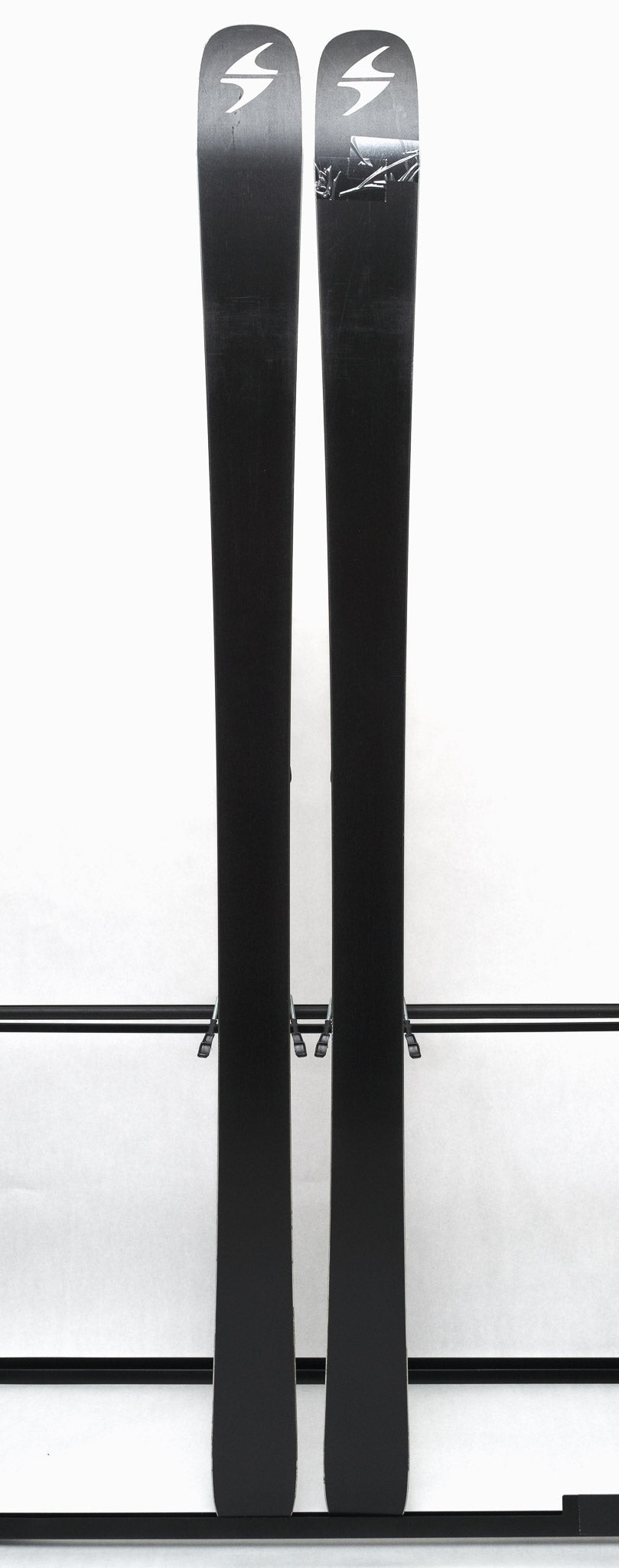 USED - Blizzard Brahma 88 with Griffon 13 Bindings - A pair of skis featuring a black base with white lettering and a distinctive logo on top, accompanied by two bindings.