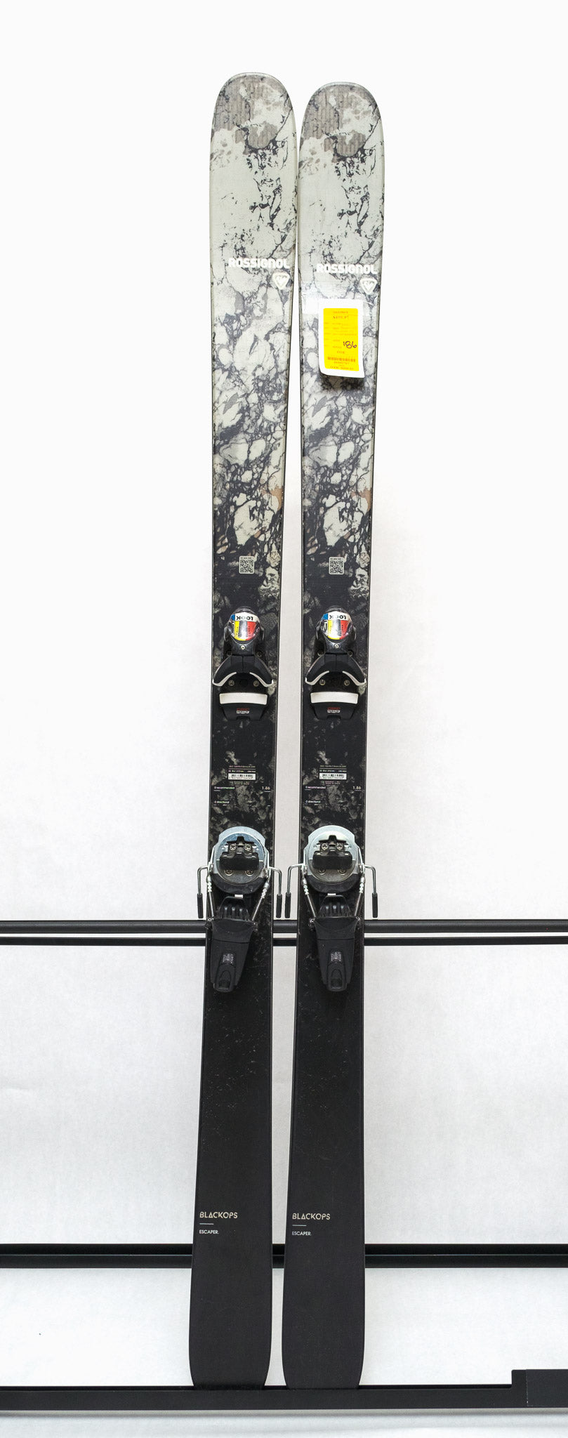 USED - Rossignol Black Ops Escaper with Pivot 12 Bindings - A pair of skis featuring a black and white marbled pattern on the tops, with silver bindings.