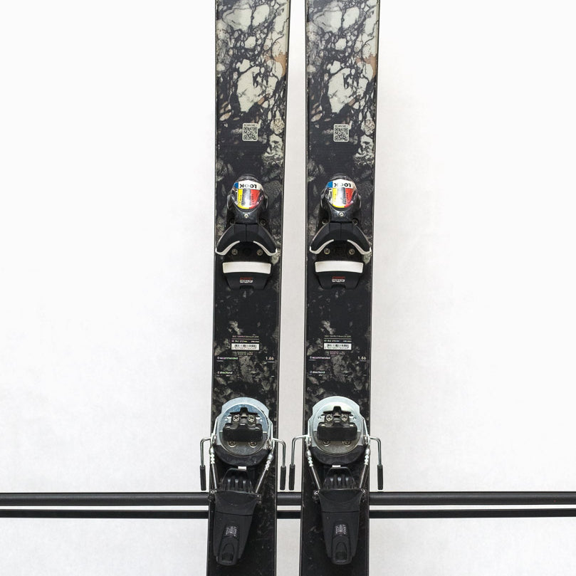 USED - Rossignol Black Ops Escaper with Pivot 12 Bindings - A pair of skis featuring a black and white marbled pattern on the tops, with silver bindings.