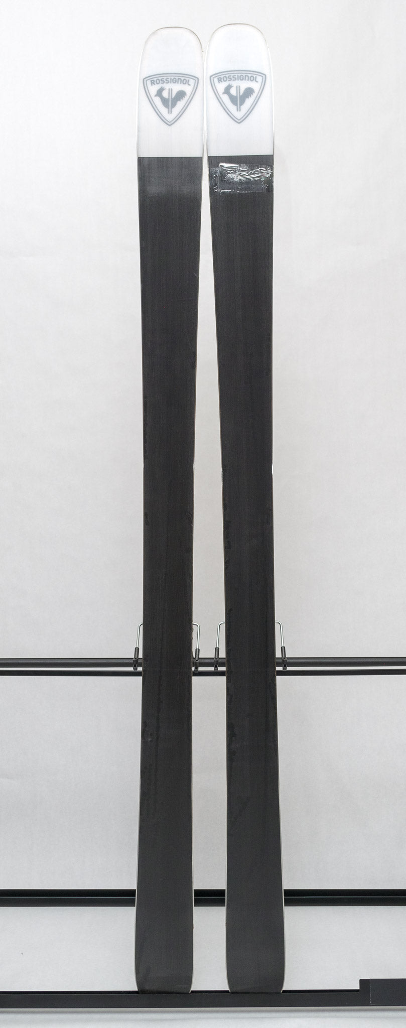 USED - Rossignol Black Ops Escaper with Pivot 12 Bindings - A pair of skis featuring a black base and white tops, with a distinctive logo on top.