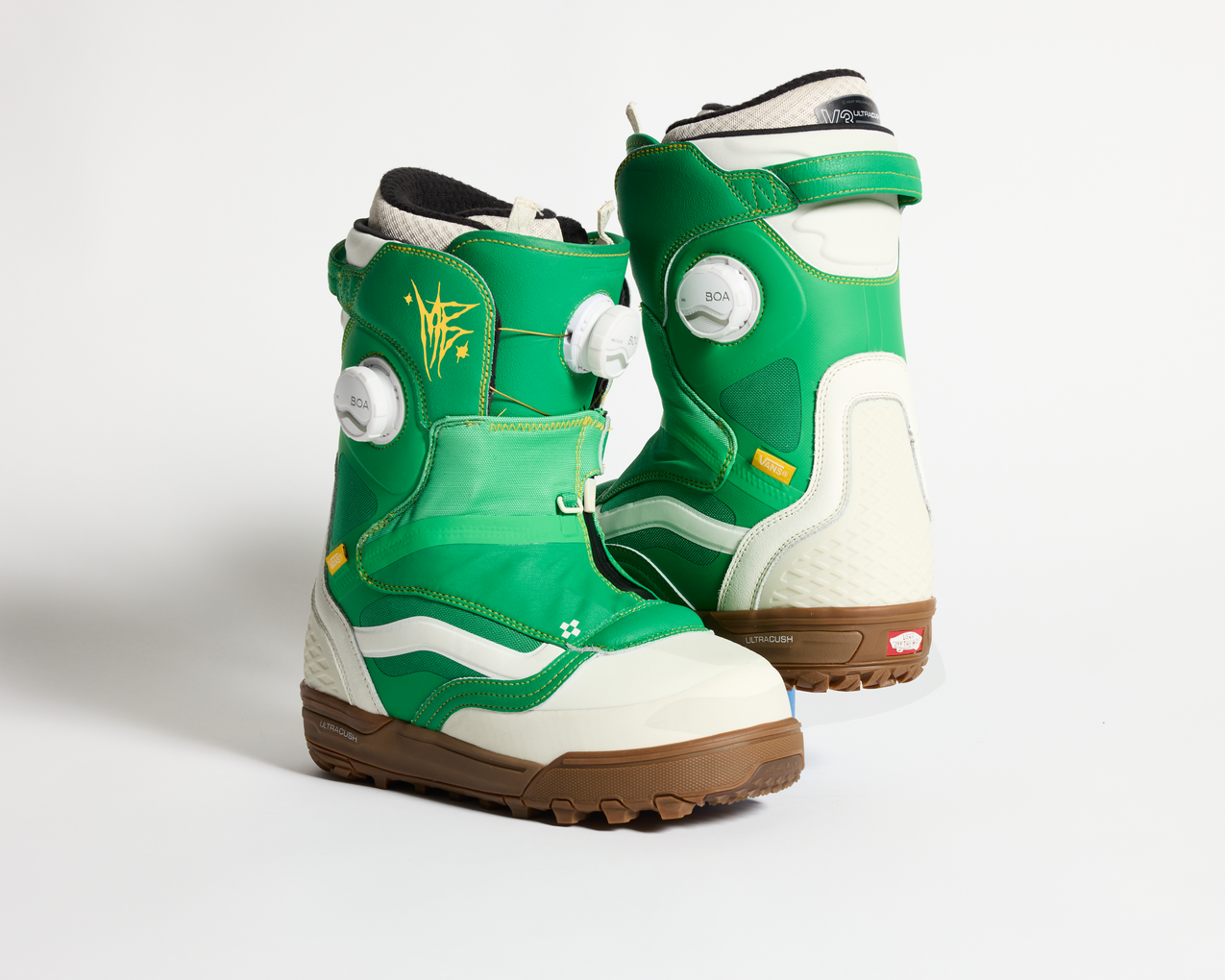 Vans green snowboard boots, side view with white panels, BOA dial, and laces