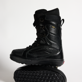 Vans black snowboard boots, high-top lace-up with padded collar and rugged tread sole.
