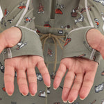 Airblaster Women's Hoodless Ninja Suit 2025 - Sage green onesie with ninja-themed cartoon graphics and white trim.