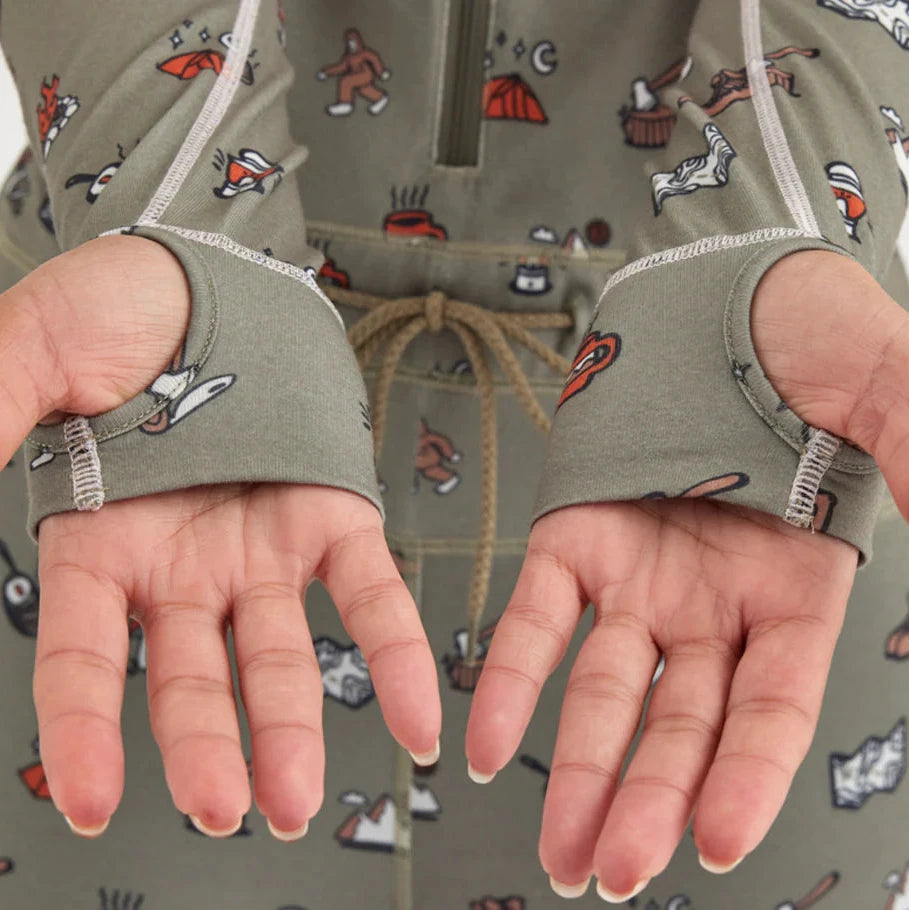 Airblaster Women's Hoodless Ninja Suit 2025 - Sage green onesie with ninja-themed cartoon graphics and white trim.