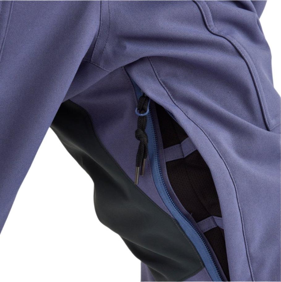 Airblaster Women's Stretch Freedom Suit 2025 - A black women's snowboard suit with a white logo on the left chest and a white stripe down the right pant leg.