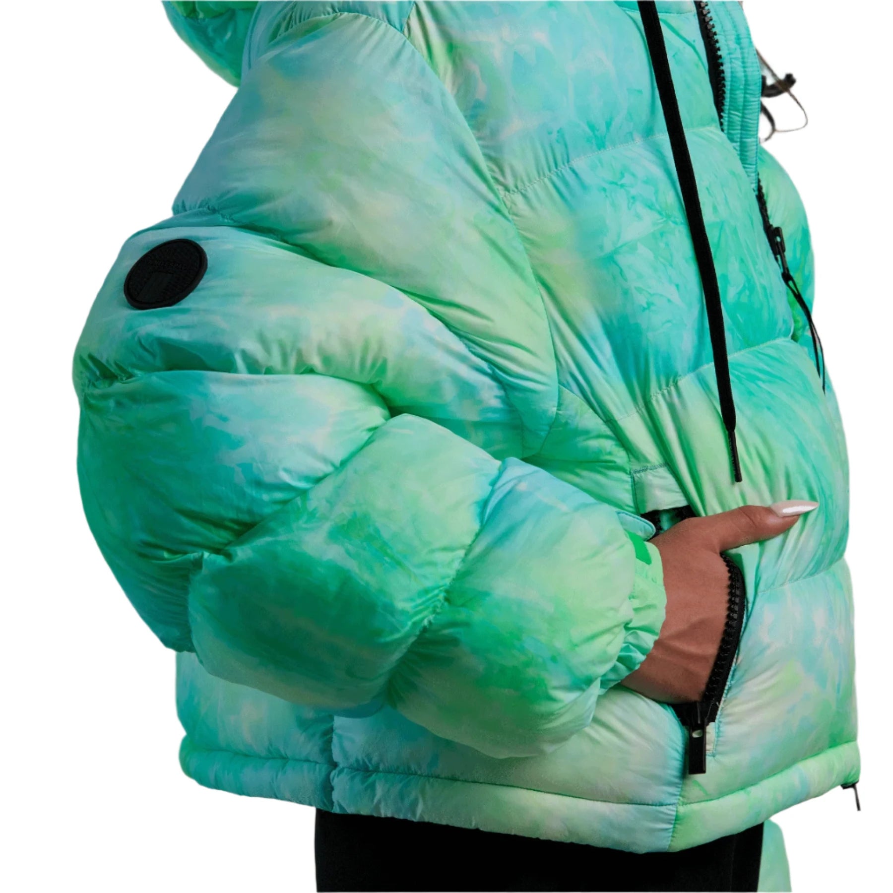 Whitespace Women's Cropped Puffer Jacket 2024 - A cropped puffer jacket with a black zipper and two black circular patches on the left arm.