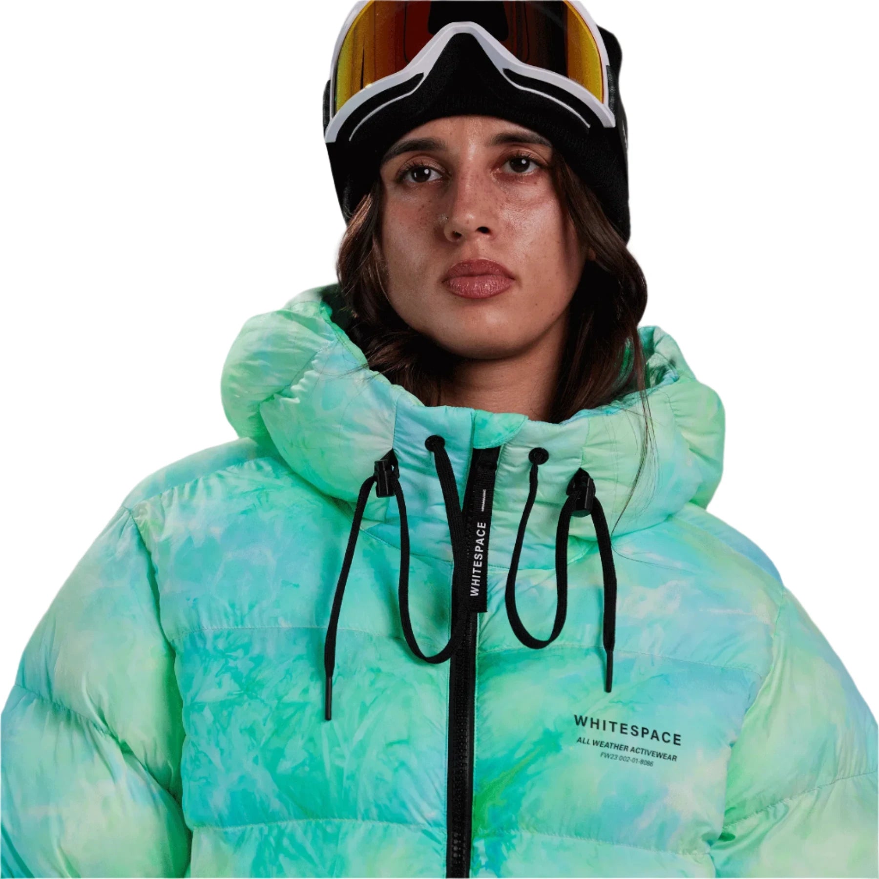 Whitespace Women's Cropped Puffer Jacket 2024 - A cropped puffer jacket with a hood in a light green and blue tie-dye pattern.