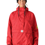 The 686 Women's Outline Shell Anorak has a red color with a black pattern and a hood.