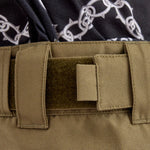 Airblaster Wrench Shell Pant 2025 - Black pants with a white chain-link pattern and spikes on the side of the leg.