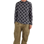 Airblaster Wrench Shell Pant 2025 - A pair of khaki-colored pants with a repeating pattern of white wrenches and bolts.