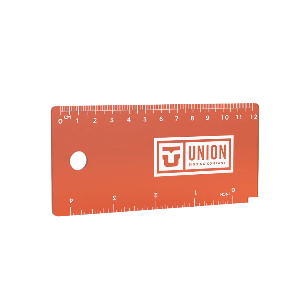 Union Wax Scraper - A rectangular wax scraper with a hole in the upper left corner, featuring an orange logo on its right side.