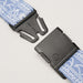 Close-up of a black plastic buckle with the brand name "Arcade" embossed on the clasp, attached to a light blue belt with a white floral and paisley pattern.