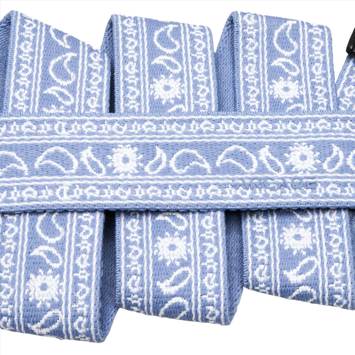 Close-up of a light blue belt with a detailed white floral and paisley pattern.