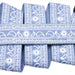 Close-up of a light blue belt with a detailed white floral and paisley pattern.