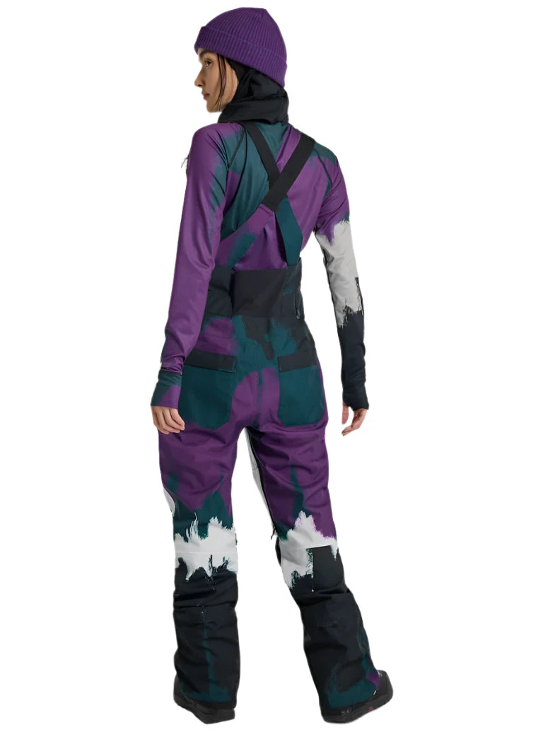 Burton Women's Avalon Stretch 2L Bib Pant 2025 - A purple and black bib pant with a pattern of abstract shapes, featuring adjustable straps on the shoulders.