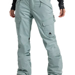 Burton Women's Gloria 2L Stretch Pants 2025 - A pair of light gray snow pants with a black logo on the left thigh and two zippered pockets on the right leg.