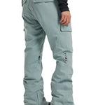Burton Women's Gloria 2L Stretch Pants 2025 - A pair of light gray snow pants with a zippered pocket on the right thigh and a small black zipper pull.