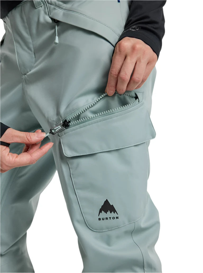 Burton Women's Gloria 2L Stretch Pants 2025 - A pair of light gray snow pants with a zippered pocket on the thigh and a black logo at the bottom.