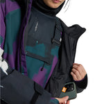 Burton Women's Lalik 2L Jacket - A purple and green camouflage patterned jacket with a black zipper on the chest pocket.