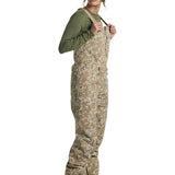 Burton Women's Reserve 2L Stretch Bib Pants 2025 - A pair of khaki-colored snow pants with a subtle floral pattern and adjustable straps.