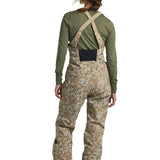 Burton Women's Reserve 2L Stretch Bib Pants 2025 - A pair of khaki-colored snow pants with a subtle floral pattern and black accents on the side pockets.
