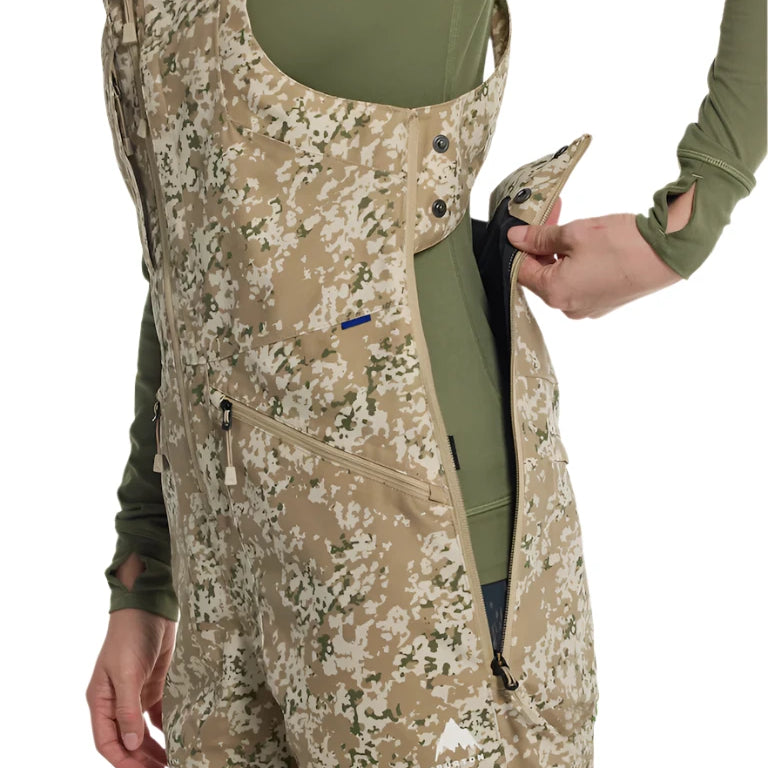 Burton Women's Reserve 2L Stretch Bib Pants 2025 - A pair of khaki-colored snow pants with a subtle floral pattern and adjustable straps at the waist.