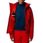 North Face Women's Lenado Insulated Jacket - A woman wearing a red insulated jacket with a black zipper and two zippered pockets on either side of her waist.