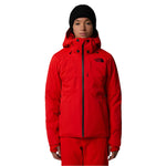 North Face Women's Lenado Insulated Jacket - A woman wearing a red jacket with black buttons and a logo on the left chest, standing against a white background.